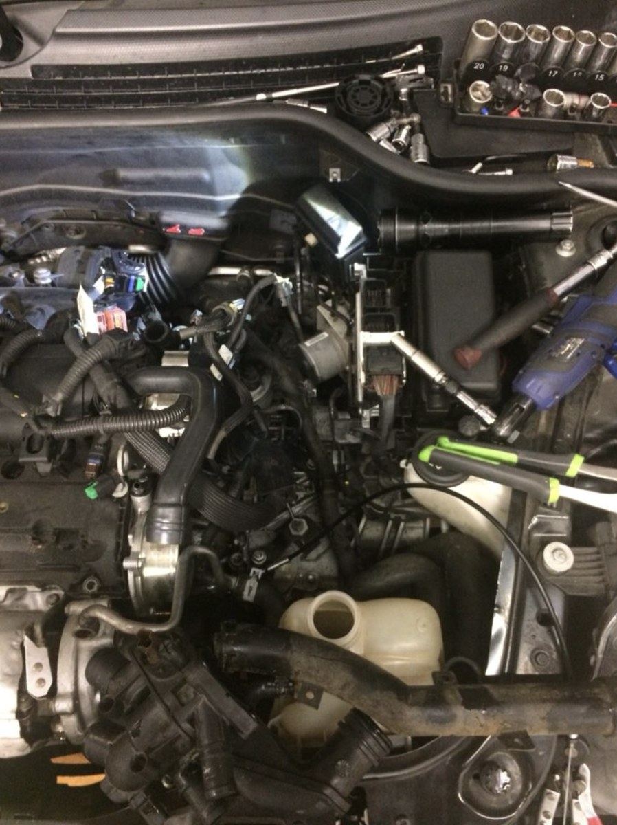 Diagnostic work deep in an engine bay at an Erie house call