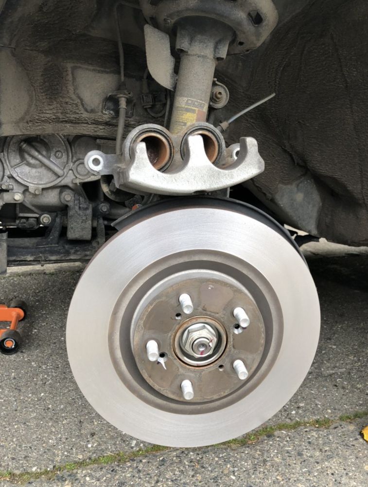 battery replacement being done on car in Millcreek neighborhood after snowfall